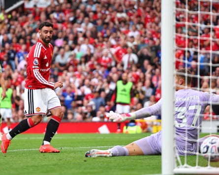The Manchester United captain Bruno Fernandes slides the ball past the Ipswich goalkeeper Kjell Scherpen to score his third goal and his team’s fourth in their 5-2 Premier League home win.