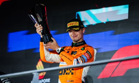 Lando Norris celebrates with the trophy after winning the Singapore Grand Prix.