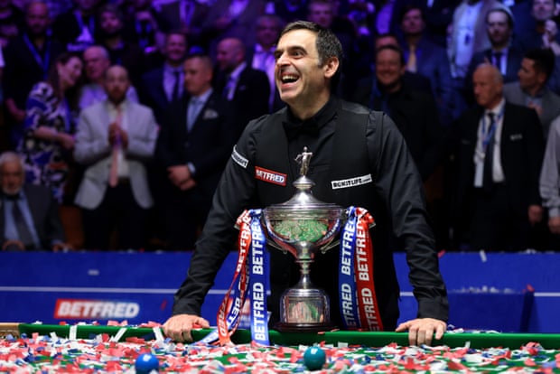 Ronnie O’Sullivan poses with the World Snooker Championship trophy after winning the World Snooker Championship final against Judd Trump.