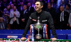 Ronnie O’Sullivan poses with the World Snooker Championship trophy after winning the World Snooker Championship final against Judd Trump.