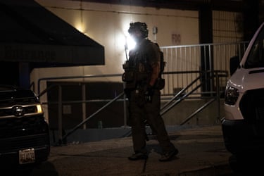 An armed law enforcement officer stands near the garage of the Washington Hilton during the White House Correspondents’ Dinner after gun shots rang out on 25 April, 2026 in Washington, DC.