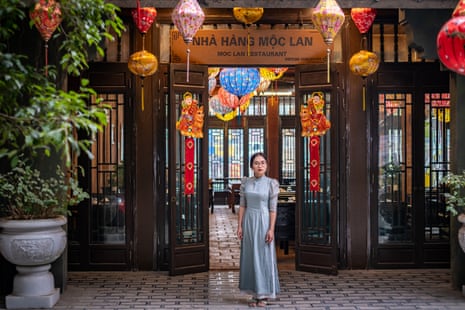 Thanh Van, 24, a hotel receptionist poses for photos in front of a restaurant near her house in Ninh Binh, Vietnam.