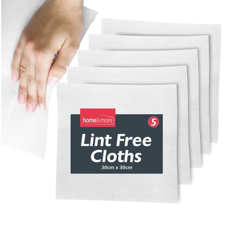 A hand using a lint free cloth in the top left of the image with five packets of SOL Lint Free Cloths are in the centre of the image.