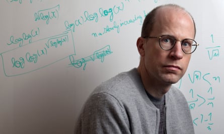 Nick Bostrom with equations written on whiteboard behind him
