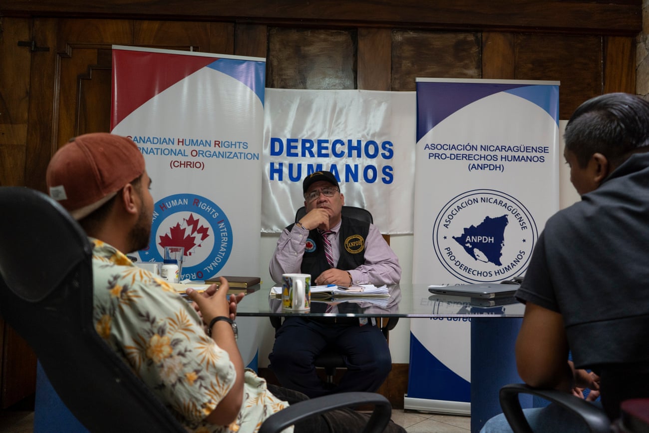 Dr. Álvaro Leiva, 55, assisting two newly-arrived Nicaraguan journalists at the office of the Nicaraguan Association for Human Rights in San José.
