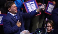 A teenage boy (Gus Walz) cries as he points his finger ahead in a crowd