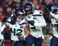 Seahawks linebacker Drake Thomas (42) is congratulated by linebacker Ernest Jones IV, middle, and cornerback Riq Woolen after intercepting a pass against the 49ers during the second half of Saturday’s game.