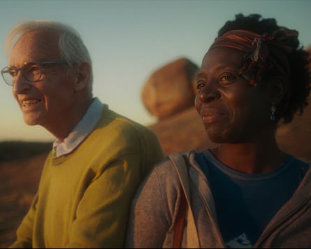 a man and woman smiling into the distance