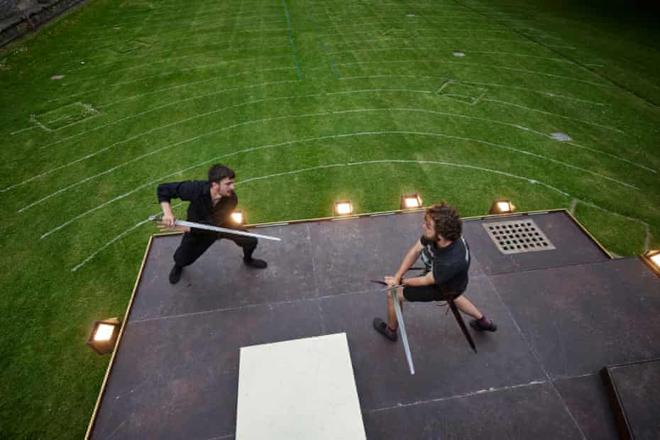 Ronnie Yorke (Macbeth) and Maximillian Marston (Macduff) practice their climactic swordfight, before audiences are admitted for the evening. Production Manager Aaron Barker draws guidelines at every venue, to ensure that audience members are able to seat themselves one metre apart from each other, for Covid-safe social distancing.