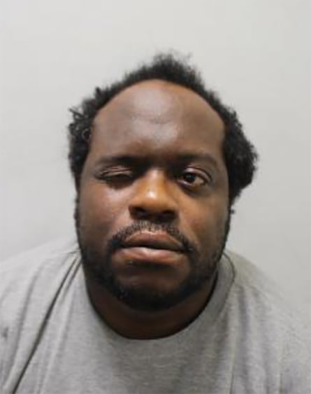 A mugshot of man wearing a grey jumper.