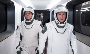 SpaceX astronauts Bob Behnken and Doug Hurley, wear white SpaceX spacesuits.