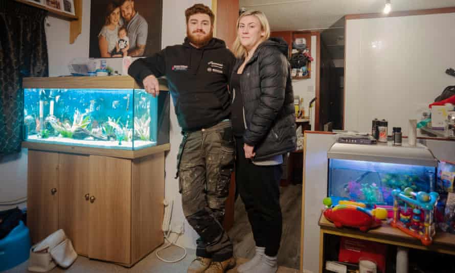 Tom Evans and Charlotte Williams inside their caravan.