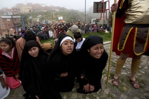 Women plays the role of Las Tres Marias, or the three Marias, in a Good Friday reenactment in La Paz, Bolivia.