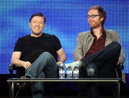 Ricky Gervais and Stephen Merchant are seated behind a low table, shot at a press conference in January 2010