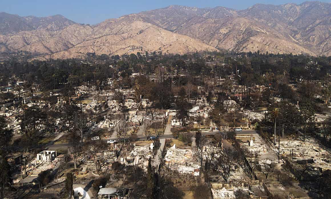 A drone view shows neighborhood blocks destroyed by the Eaton fire in Altadena, California