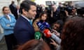 André Ventura talks to the media in a street outside a polling station
