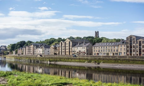 The converted warehouses on St Georges Quay, Lancaster, with the Priory Church on Castle Hill behind.