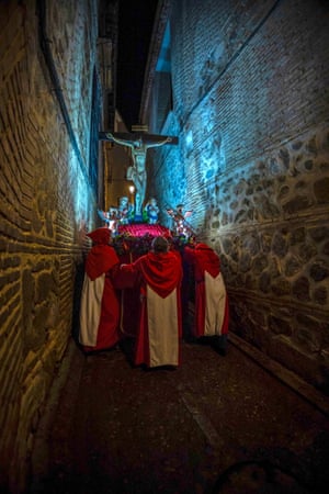 Toledo, Spain. Catholics carry the Christ of Angels float along a narrow passage during a procession to mark Holy Week