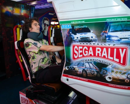 Pete Wise wears a travel pillow around his neck in an arcade