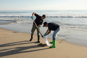 Daniel Orr (left) and Peter Boucher, Environmental Scientists with the California Department of Fish and Wildlife, help with beach cleanup.