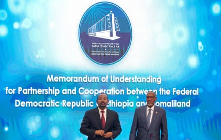 Somaliland’s former president Muse Bihi Abdi and Ethiopia’s prime minister Abiy Ahmed stand in front of a screen which reads ‘Memorandum of Understanding for Partnership and cooperation between the Federal Democratic Republic of Ethiopia and Somaliland.