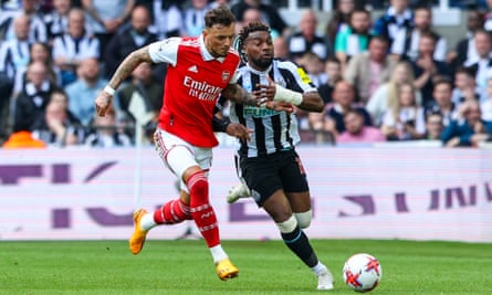 Arsenal’s Ben White battles with Newcastle United’s Allan Saint-Maximin during a Premier League match between the two teams
