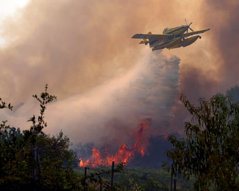An Air Tractor AT-802F Fire Boss aircraft dumps water over a wildfire burning near San Martin de Valdeiglesias, about 70km west of Madrid, on Sunday.