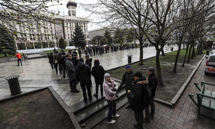 Ukrainians queue to buy stamps commemorating the Snake Island incident outside the main post office in Kyiv.