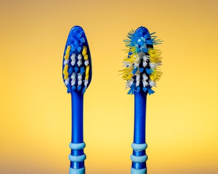 Old used and new toothbrush isolated on a yellow background