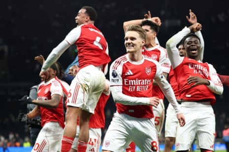 Arsenal players celebrate winning at Tottenham.
