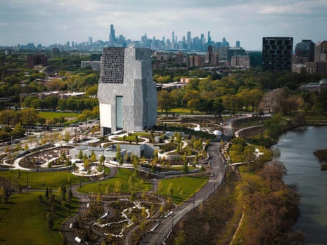 An aerial view shows the Obama Presidential Center tower rising from landscaped Chicago grounds near water