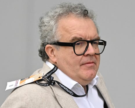 Tom Watson wearing glasses and a lanyard