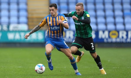 Oliver Norburn carries the ball away from Ryan McLaughlin during Shrewsbury’s game against Rochdale in October.