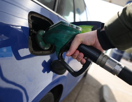 A person refuels a car at a petrol forecourt in London, Britain