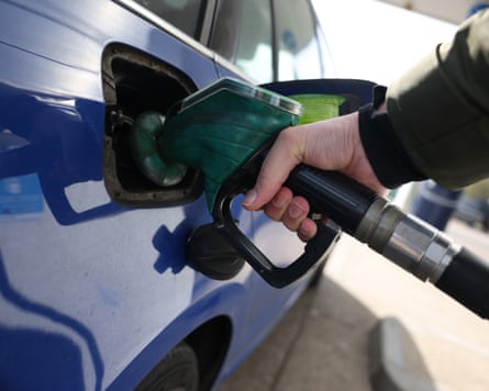 A person refuels a car at a petrol forecourt in London