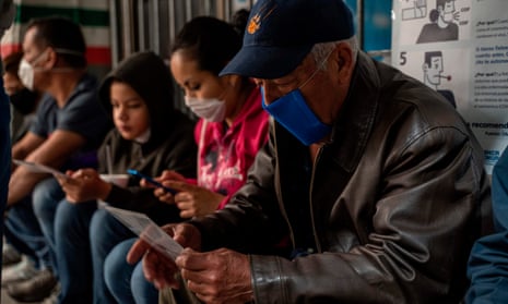 Mauricio, 66, from Honduras looks at a brochure on Covid-19 in Ciudad Juarez. A US policy that seeks to expel migrants because of the pandemic violates the law, the UN says.