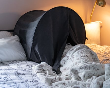 A photo of a person using a zDen in bed