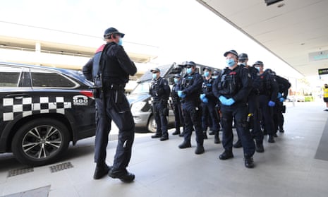Victoria police stand outside a shopping centre in Melbourne