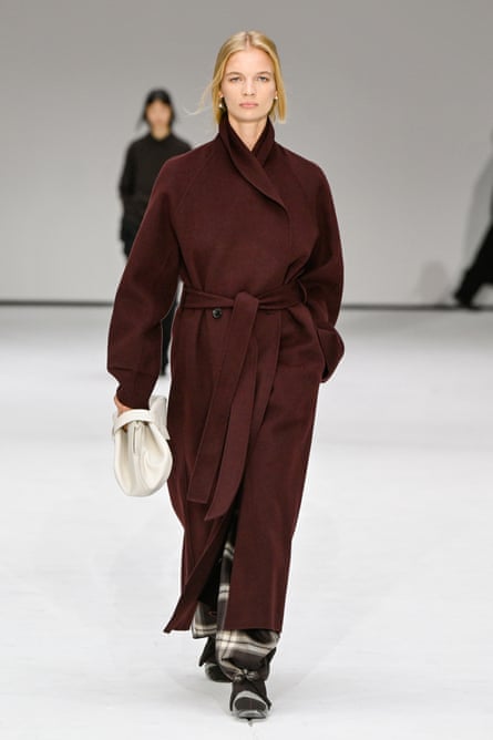 A model in a burgundy coat