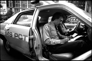 Policemen sitting in a car doing paperwork
