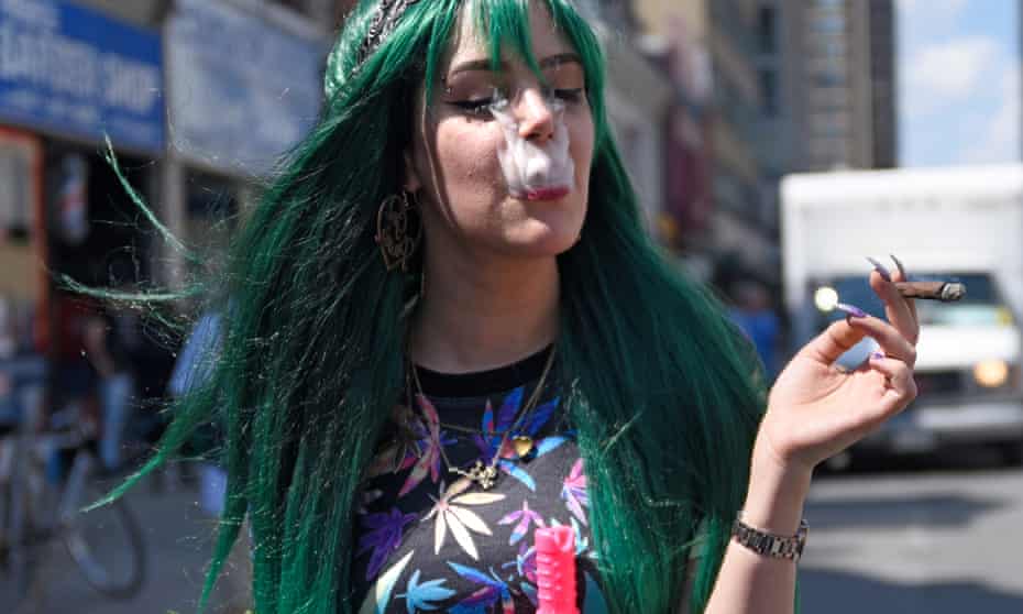 A teenage girl smoking up Marijuana during the Toronto Global Marijuana march.