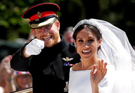 Prince Harry in a dress uniform and Meghan Markle in a wedding dress in a carriage