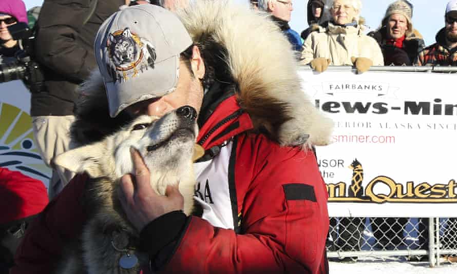 Hugh Neff hugs his lead dog, George, after winning the Yukon Quest sled dog race.