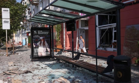 A local resident stands amid shattered glass and debris from the Chernihiv attack