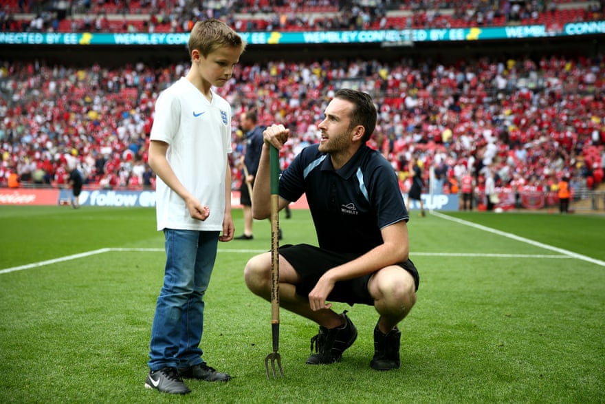 Karl Standley (kneeling) with a competition winner at Wembley stadium in 2014.