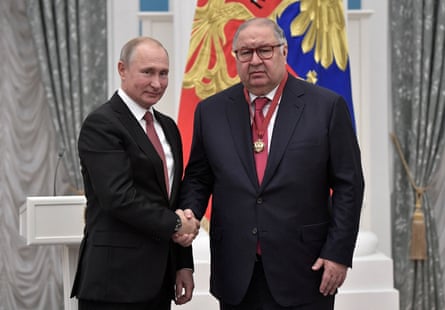 Russian president Vladimir Putin (left) shakes hands with Alisher Usmanov
