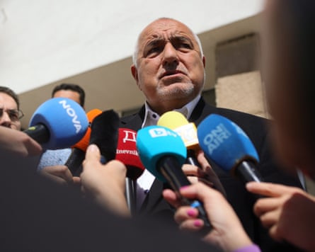 Boyko Borissov speaks to journalists holding up microphones