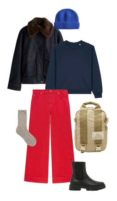 A composite image of a denim jacket with faux fur collar, blue knitted beanie hat, navy sweatshirt, red jeans, beige backpack, black chunky ankle boots and beige marl socks, all on a white background