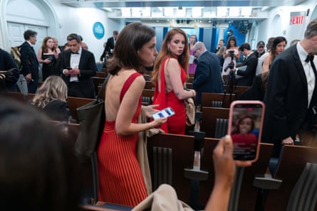 Women and men in gowns and tuxedos standing