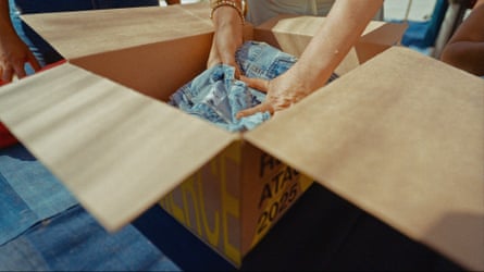 Denim clothes are packed into a cardboard box
